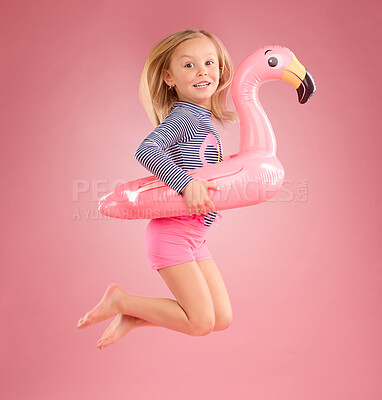 Buy stock photo Jump, smile and portrait of girl and pool float for swimming, summer break or happiness. Youth, funny and inflatable with child and flamingo ring for cute, happy or beach holiday on pink background