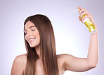 Beauty smile, hair care and woman with spray in studio isolated on a gray background. Cosmetics, eyes closed and happy female model with hairspray product for salon treatment, growth and hairstyle.