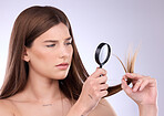 Hair care, beauty and woman with magnifying glass in studio isolated on a background. Cosmetics, face and sad female model with magnifier for hairstyle health inspection, salon treatment or growth.