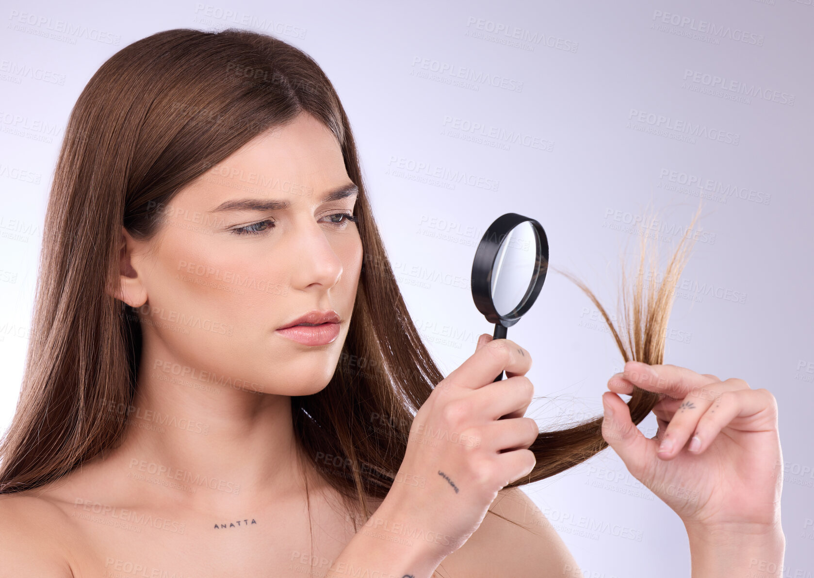 Buy stock photo Hair care, beauty and woman with magnifying glass for split ends in studio isolated on a background. Cosmetics, face and sad female with lens for hairstyle, hairloss or damage after salon treatment.