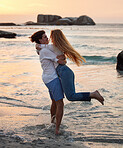 Couple in ocean, freedom and travel, love and commitment in relationship, man swing woman with adventure at beach. Trust, partnership and care with people outdoor, romance and happiness at sunset