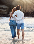 Back, hug and couple walking, beach and quality time on summer vacation, weekend break and romance. Romantic, man and woman embrace, love and happiness for holiday, journey and adventure together