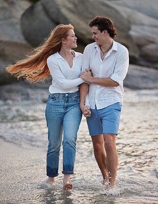 Buy stock photo Love, holding hands and happy with couple at beach for romance, relax and vacation trip. Travel, sweet and cute relationship with man and woman walking on date for summer break, trust and bonding