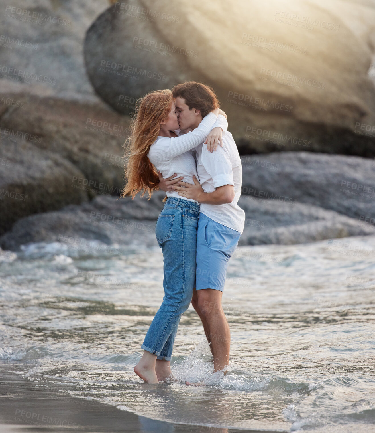 Buy stock photo Love, kiss and happy with couple at beach for romance, relax and vacation trip. Travel, sweet and cute relationship with man and woman kissing on date for summer break, affectionate and bonding