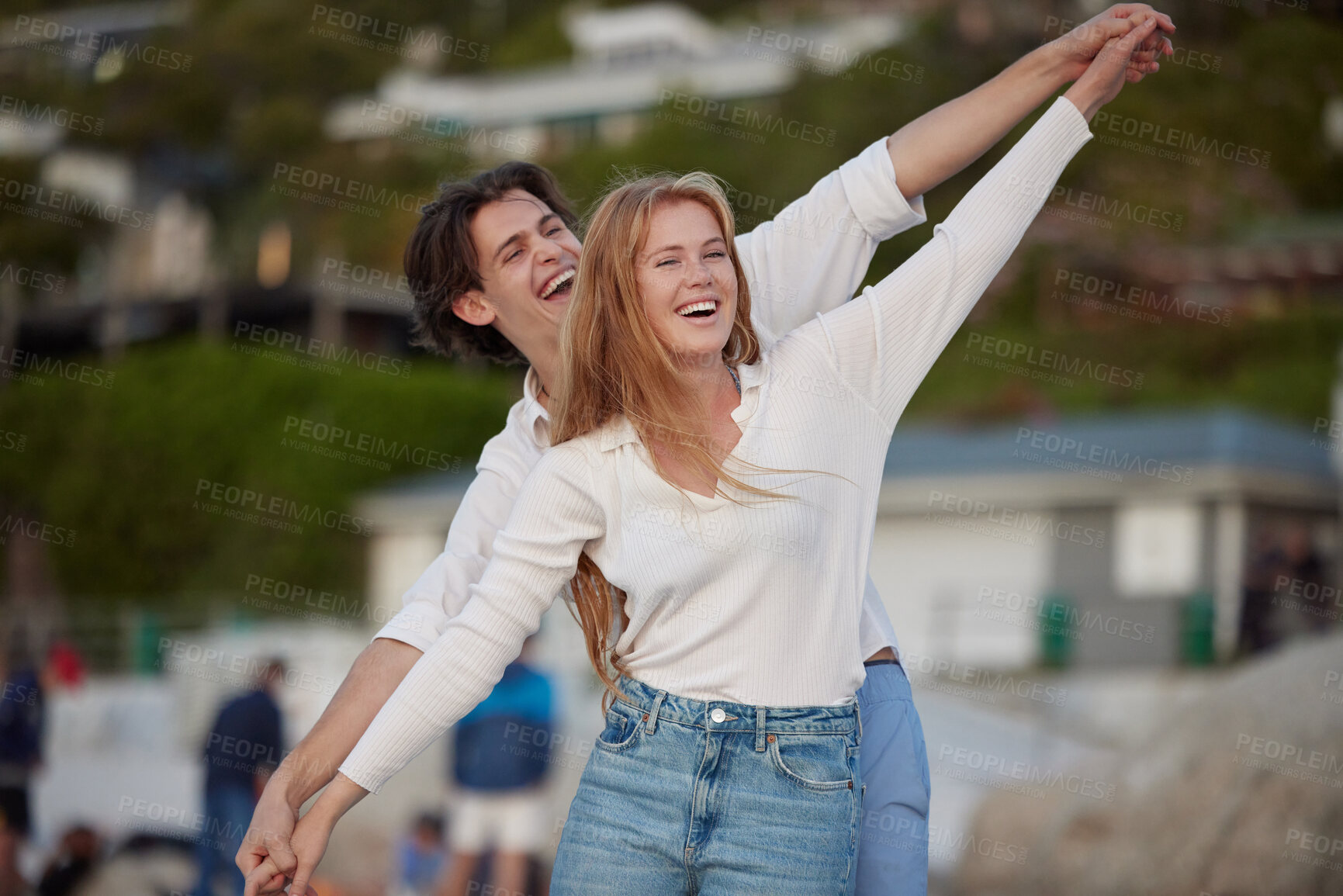 Buy stock photo Flying, happy and laughing couple at the beach for a date, honeymoon and bonding in Bali. Smile, comic and playful man and woman with care, love and affection at the sea for happiness together
