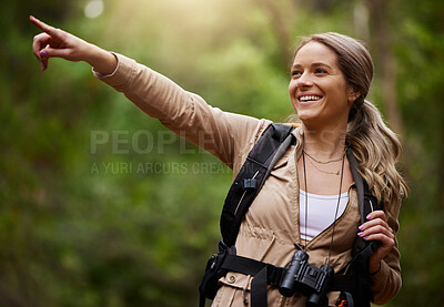 Buy stock photo Happy hiker pointing or woman in hiking nature, forest or wilderness for a trekking adventure. Freedom, backpack or healthy female walking in natural park or woods for exercise or wellness on holiday