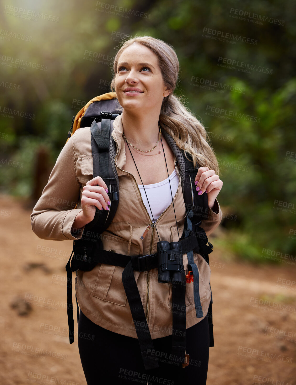 Buy stock photo Hiking, smile and forest with a woman outdoor, walking in nature or the wilderness for adventure. Freedom, thinking and woods with an attractive young female hiker taking a walk in a natural park