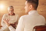 Psychologist, counseling or man consulting in therapy, mental healthcare or support in consultation. Back view of patient talking to writing or listening senior therapist for medical help or advice 