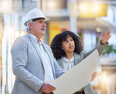 Buy stock photo Man, woman and pointing at construction site for blueprint ideas, industrial design or collaboration. Team discussion, building management and engineering of infrastructure, architecture and planning