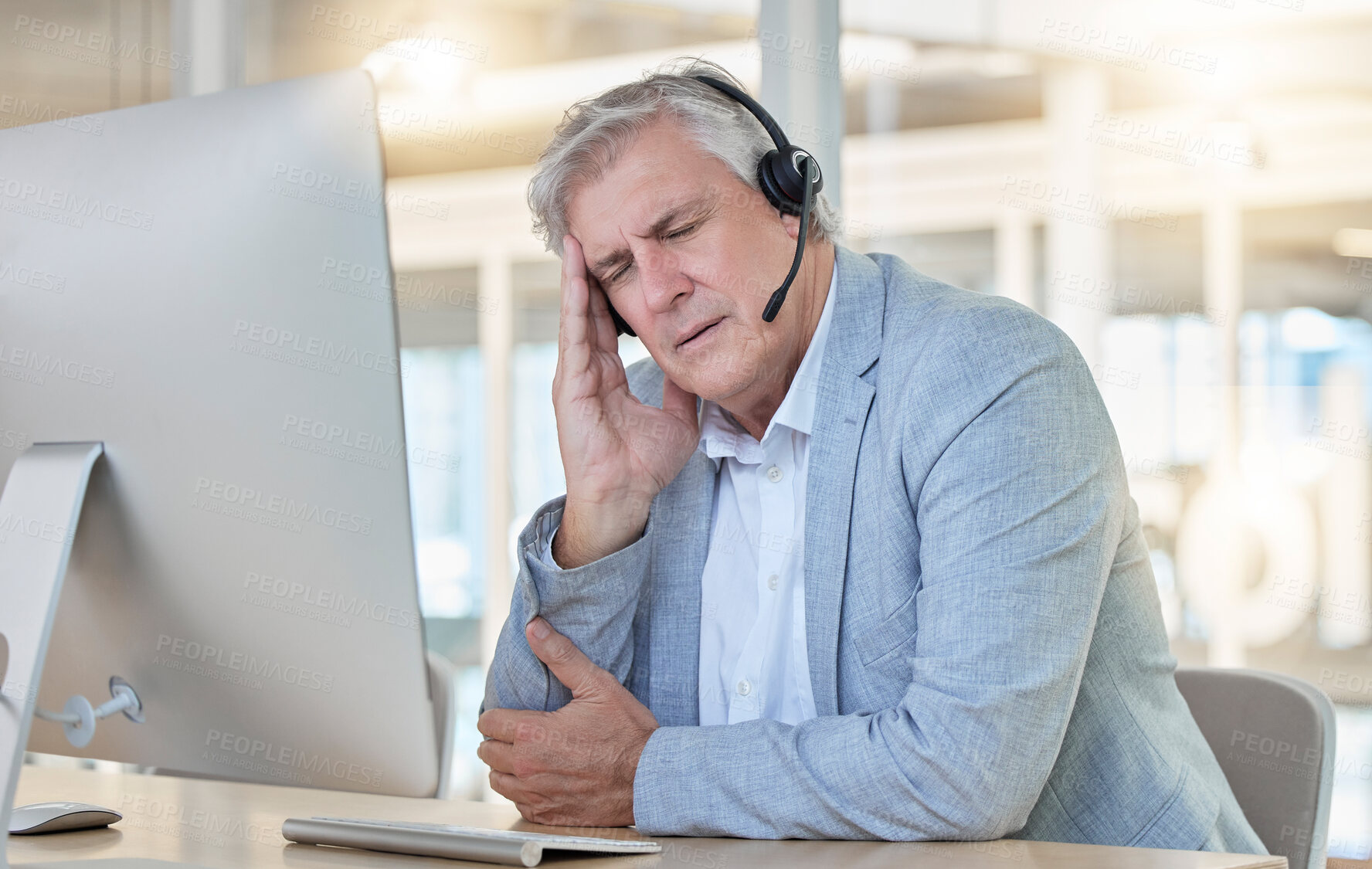 Buy stock photo Call center, customer service and headache with a consultant man suffering from pain while working in the office. Crm, support and burnout with a senior male telemarketing working feeling stress