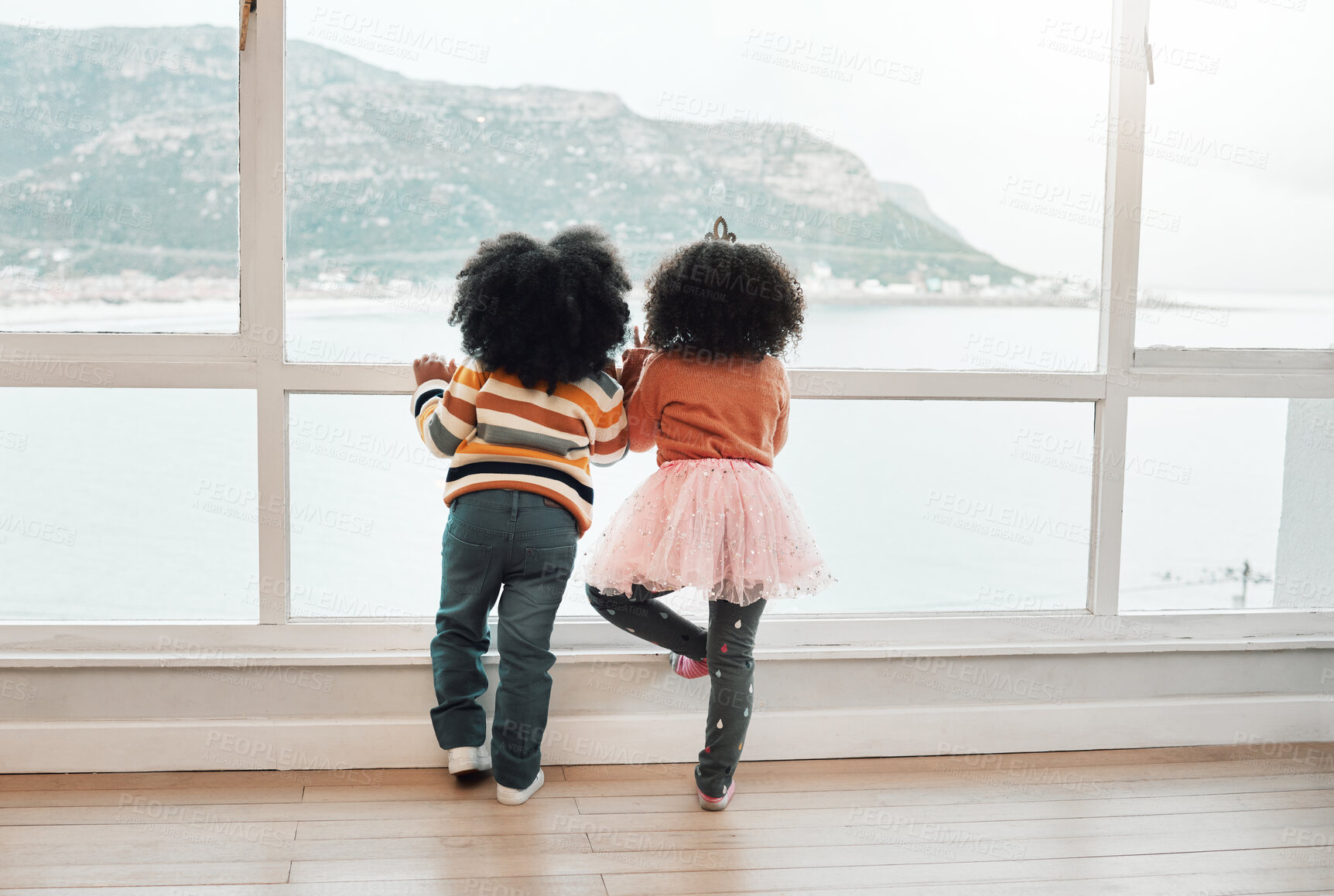 Buy stock photo View, back and children looking from a window for play, beach and childhood together. Indoors, standing and kids waiting in a house to visit the sea on a vacation or holiday at the ocean for playing