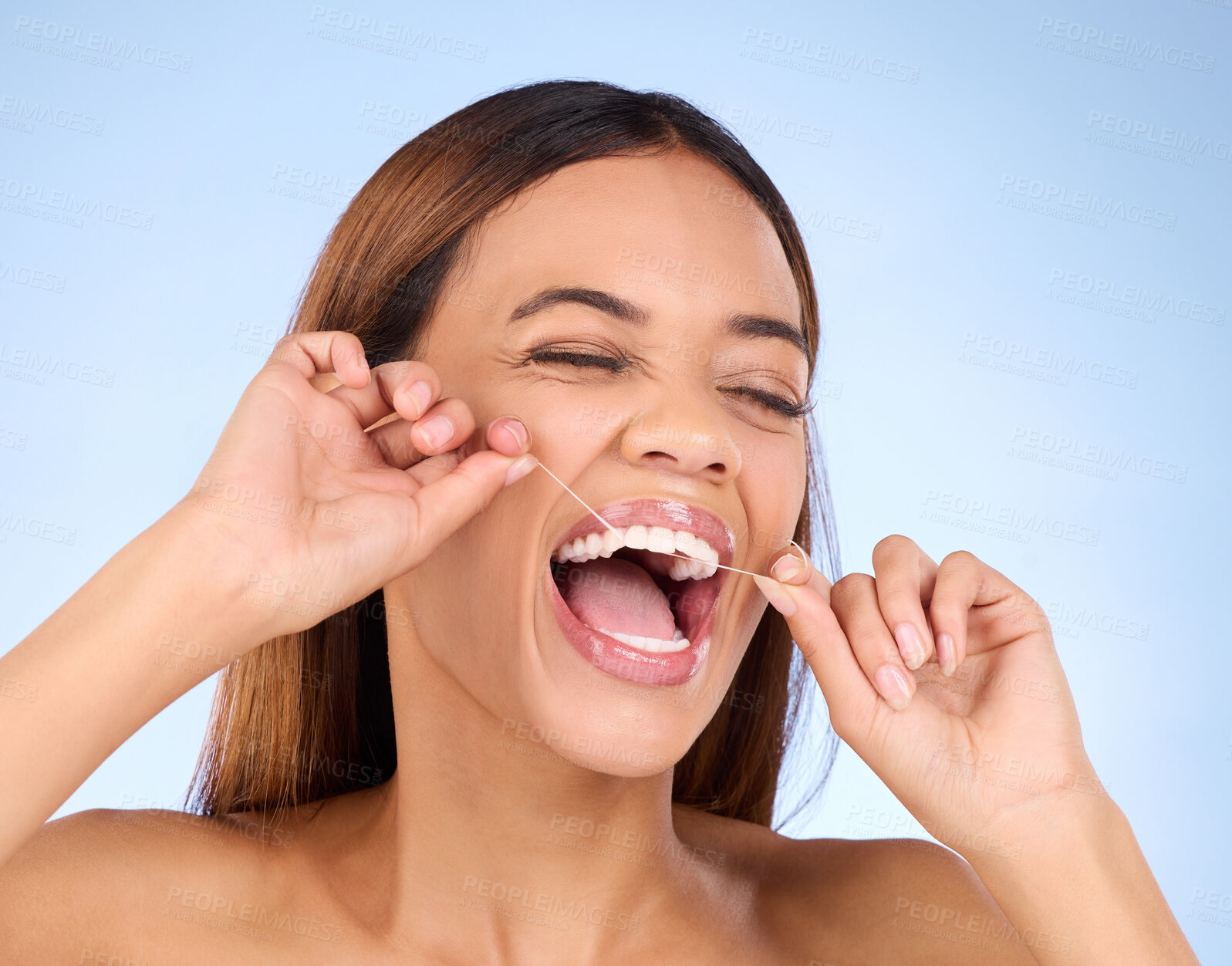 Buy stock photo Dental floss, tooth cleaning and woman smile with teeth hygiene, healthcare and wellness treatment. Isolated, blue background and studio with a female feeling beauty from a clean mouth with self care