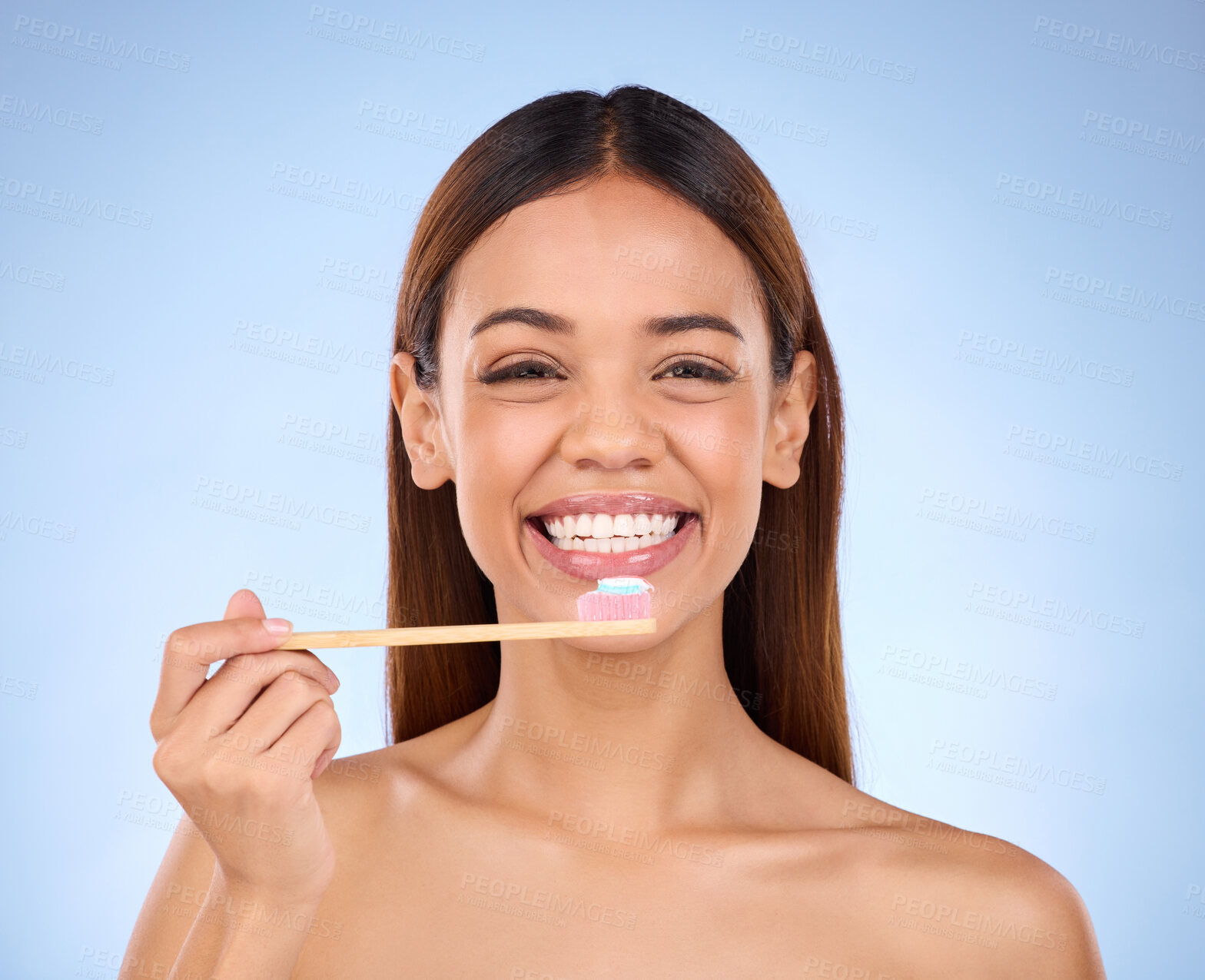 Buy stock photo Toothbrush, portrait and dental with a woman in studio on a blue background for oral hygiene. Mouth, dentist and cleaning with an attractive young female brushing her teeth for healthy gums