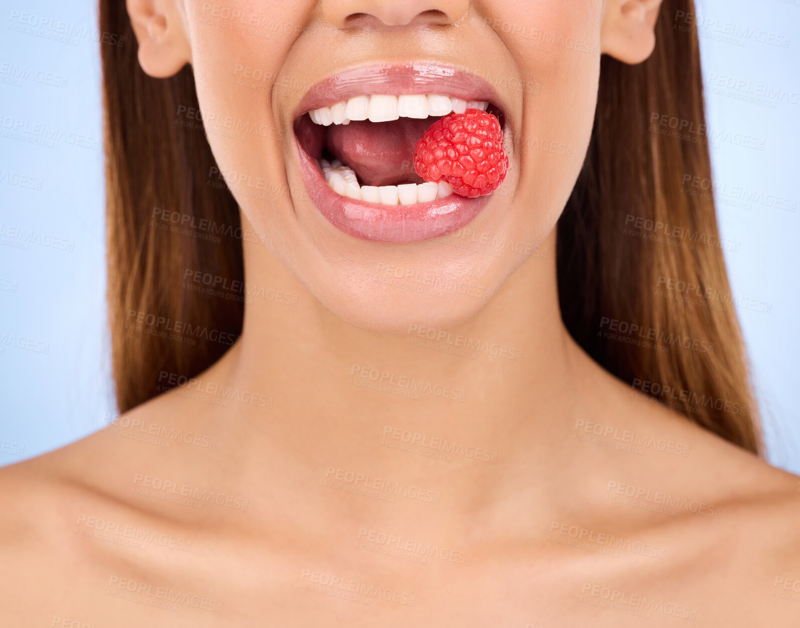 Buy stock photo Woman, mouth and raspberry for skincare nutrition, dermatology or diet health plan against a studio background. Female lips with fruit for natural organic food, self care or eat for healthy wellness