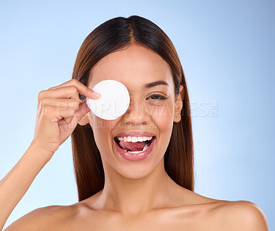 Buy stock photo Beauty, woman and face with cotton pad for skincare dermatology cosmetics in studio. Female model person on a blue background for self care, facial glow and healthy or detox skin with clean results