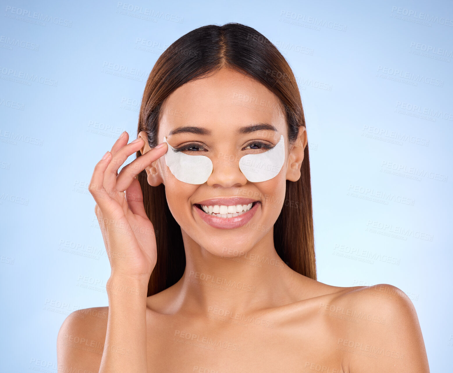 Buy stock photo Skincare, beauty and portrait of happy woman with eye mask for anti aging or skin glow on blue background. Cosmetics, facial repair pads and face of model with collagen product and smile in studio.