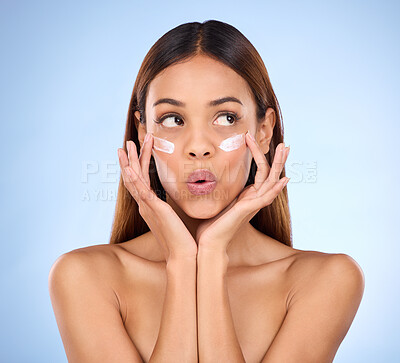 Buy stock photo Skincare, beauty and dermatology, woman with eye cream and anti aging skin care wow on blue background. Cosmetics, facial repair and surprise, face of hispanic model with product in studio promo.