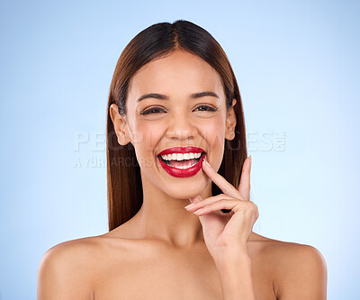 Buy stock photo Beauty, happy woman and red lipstick makeup portrait with cosmetics on face in studio. Aesthetic female model person laughing on blue background for self care, facial glow and shine or color for skin