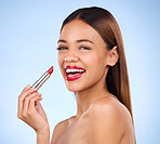 Beauty, woman and red lipstick or makeup portrait for face cosmetics in studio. Aesthetic female model on a blue background for self care, facial glow and color application for lips with a smile