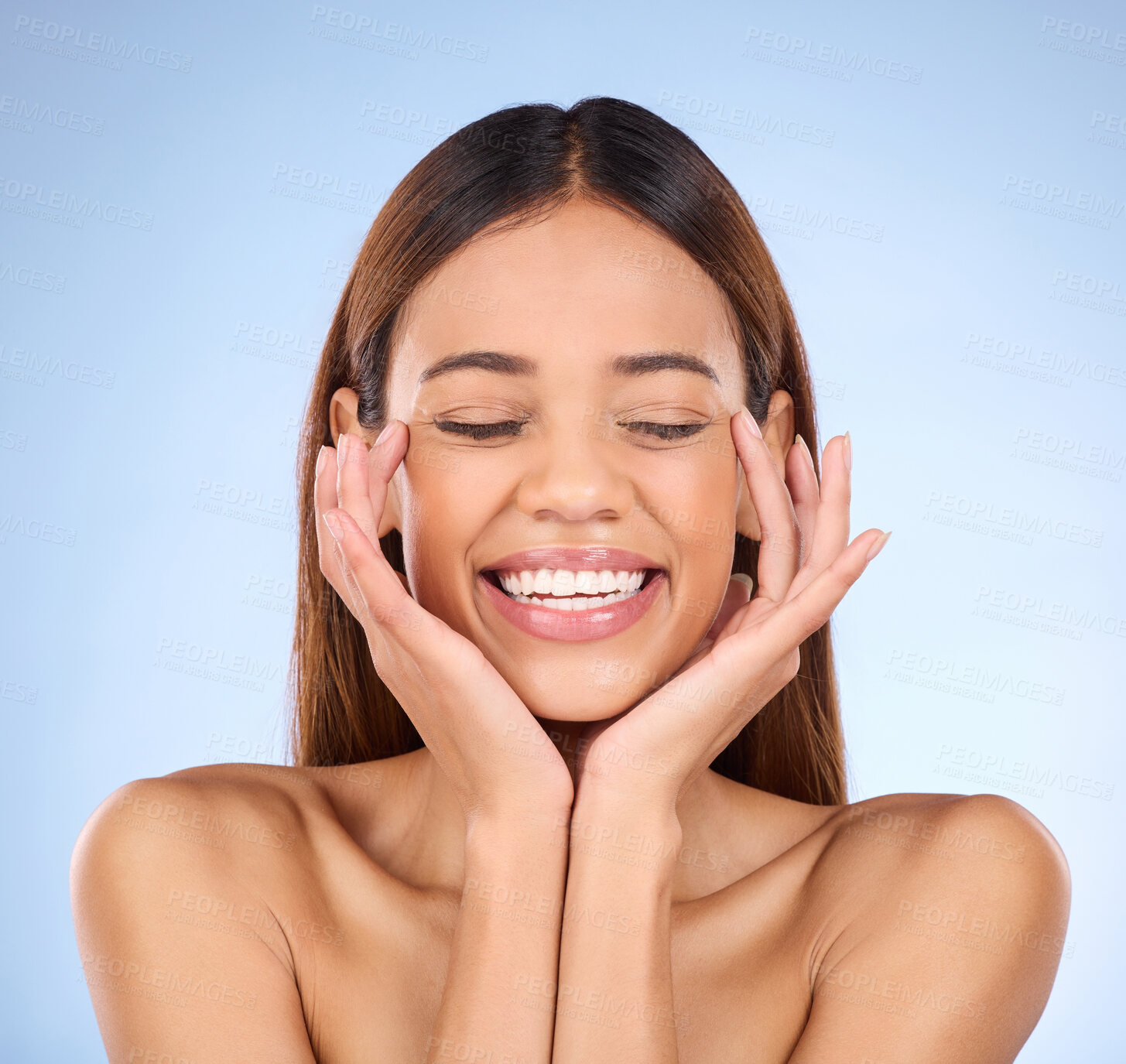 Buy stock photo Skincare, beauty and happy woman touching face with smile for skin care glow promo on blue background. Makeup, facial massage and cosmetics, hispanic model for dermatology spa promotion in studio.