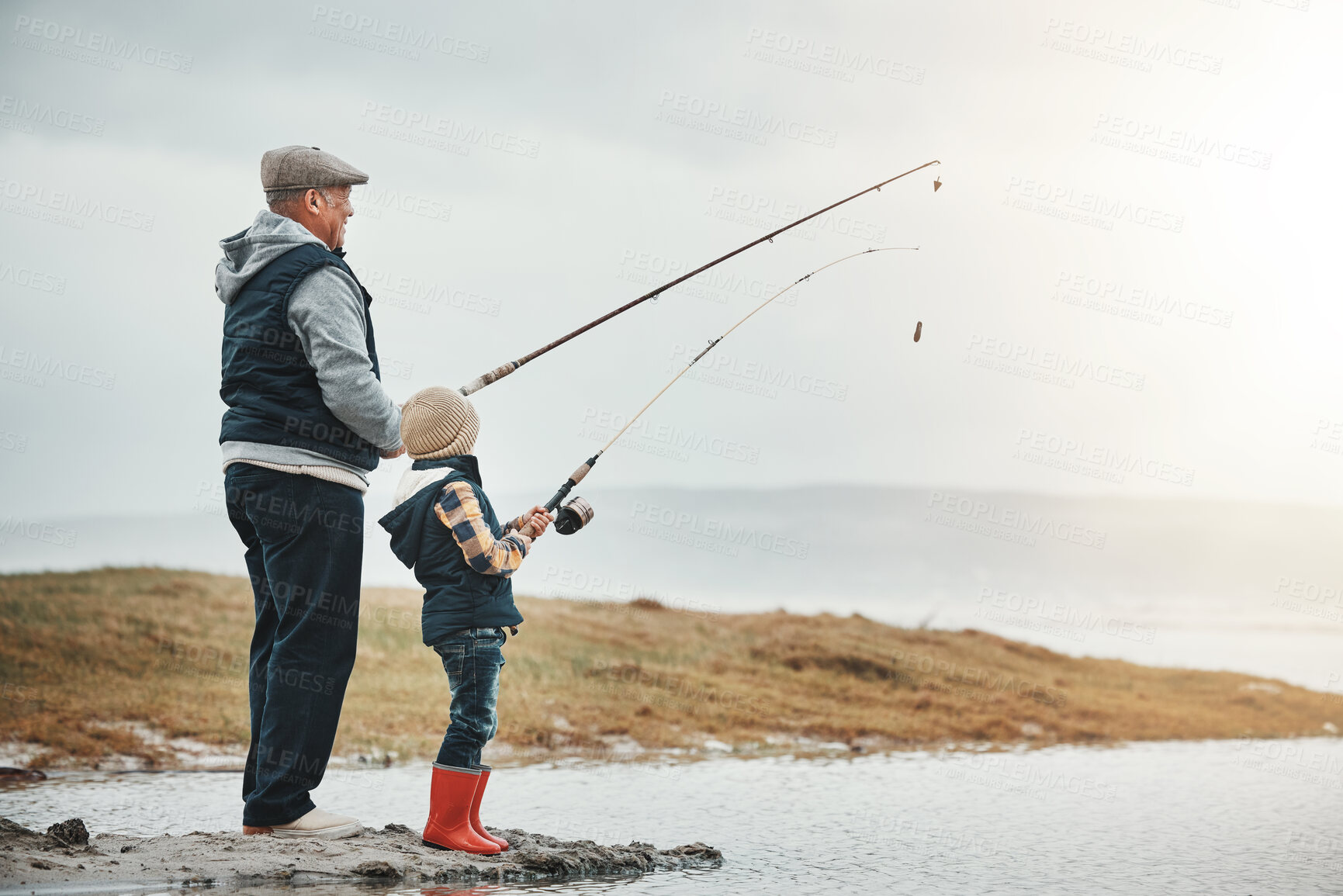 Buy stock photo Lake, travel and grandfather fishing with a kid while on a adventure, holiday or weekend trip. Hobby, outdoor and elderly man teaching a child to catch fish in nature while on vacation in countryside