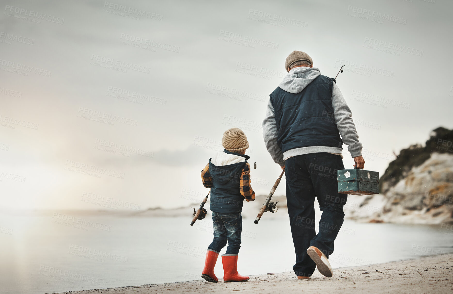 Buy stock photo Walking, back and child with grandfather for fishing, bonding and learning to catch fish at the beach. Morning, holiday and boy on a walk by the sea with an elderly man to learn a new hobby together