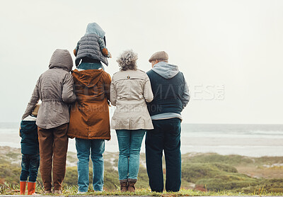 Buy stock photo Family hiking outdoor, generations at beach together with nature view and back, spending quality time in winter. Grandparents, parents and children, love and care with people at the coast