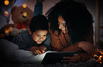 Movie, dark and a mother and child with a tablet before bedtime for a show, video or meme. Happy, streaming and a mom and boy kid watching a film, cartoon or series online with technology at night