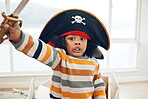 Pirate, box and portrait of black child in living room for creative, playful and fantasy. Sailing, games and imagine with kid playing in cardboard boat at home for comedy, childhood and youth