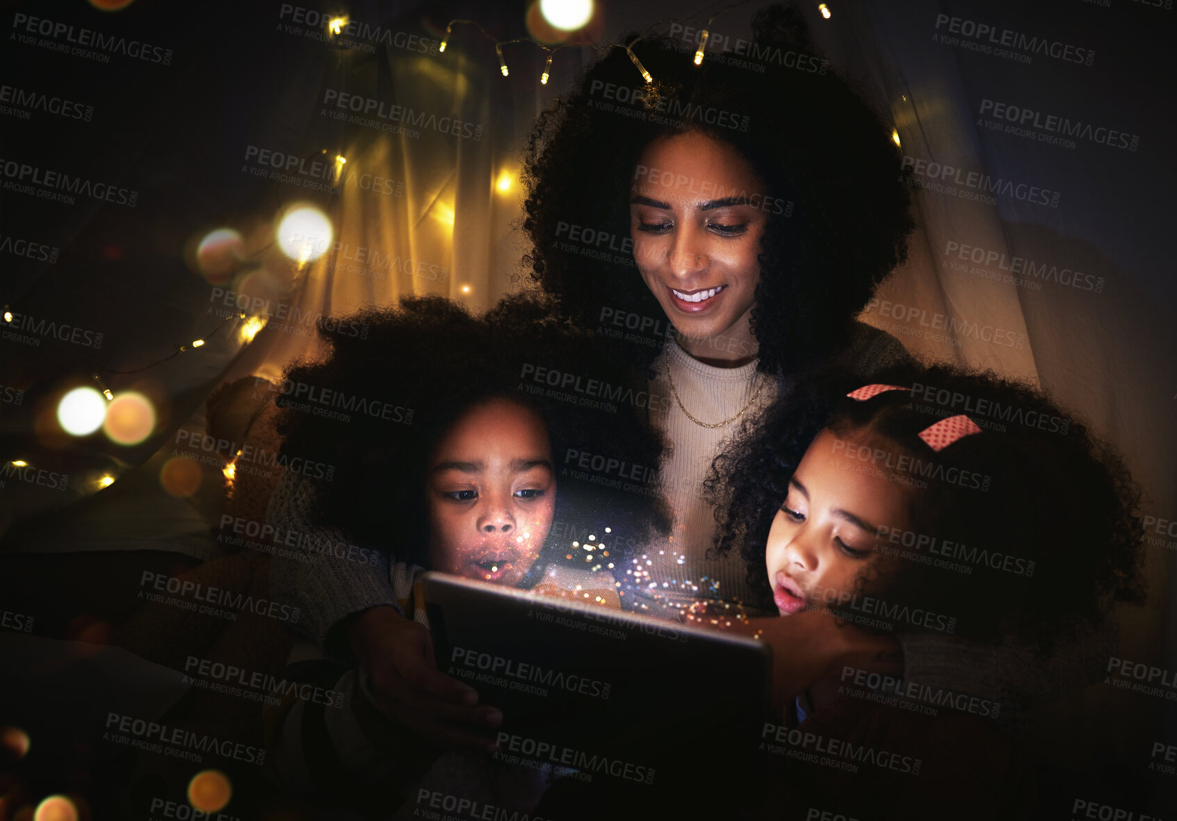 Buy stock photo Tablet, night a mother reading to her kids in a tent while camping in the bedroom of their home together. Black family, story or children with a woman storytelling to her kids at bedtime for bonding