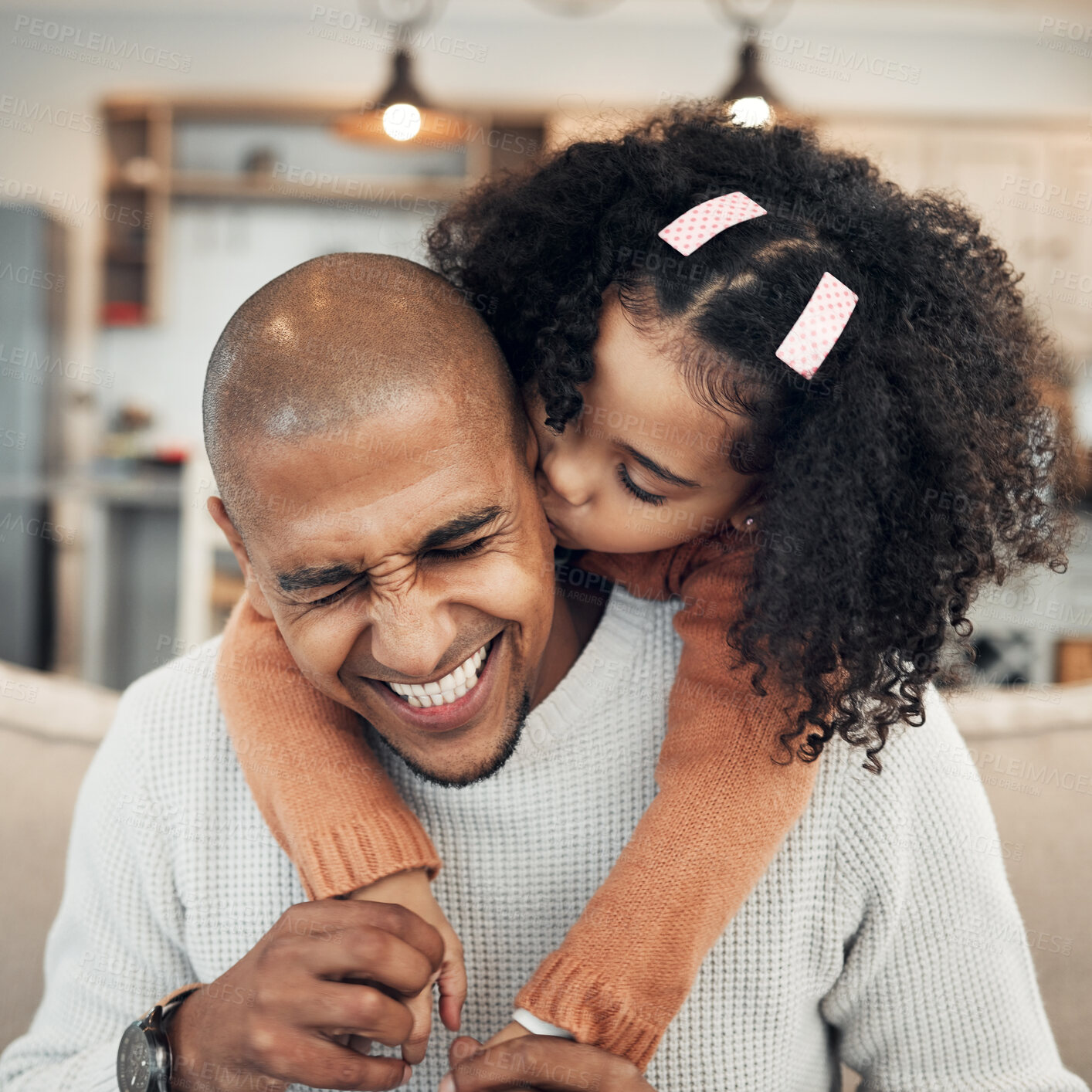 Buy stock photo Family, hug and girl kissing father on sofa, happy and laugh, playing and bonding in their home. Piggyback, embrace and child with parent on couch, sweet and hugging while having fun in living room