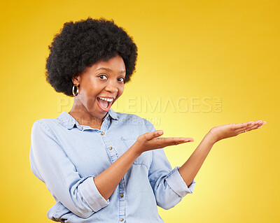 Buy stock photo Space, portrait of a black woman in studio showing mockup for advertising or marketing. Happy, smile and face of African female model pointing to mock up for product placement by yellow background.