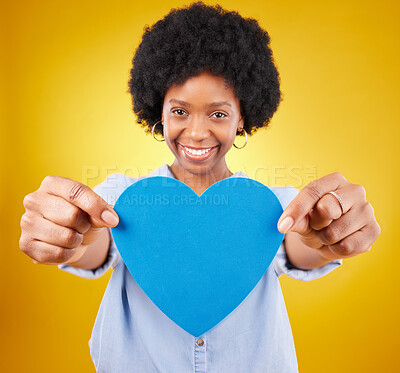 Buy stock photo Paper, heart and portrait of black woman in studio for romance, positive and emotion. Happiness, love and giving with female isolated on yellow background for date, feelings and affectionate