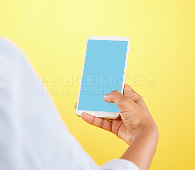Buy stock photo Phone mockup, hands and green screen in studio isolated on a yellow background. Cellphone, social media and black woman typing on smartphone for advertising space, marketing or product placement.