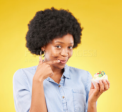 Buy stock photo Black woman, cupcake and studio portrait for smile, temptation or cheat with junk food by yellow background. African model, cake of diet choice for health, nutrition or sweets with decision for meal