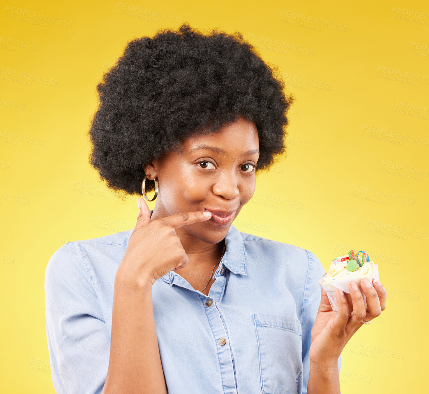 Buy stock photo Black woman, cupcake and studio portrait for smile, temptation or cheat with junk food by yellow background. African model, cake of diet choice for health, nutrition or sweets with decision for meal