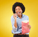 Happy, smile and popcorn with black woman in studio for movie, streaming service and cinema. Laugh, comedy and theatre with female and snack isolated on yellow background for food, tv and film