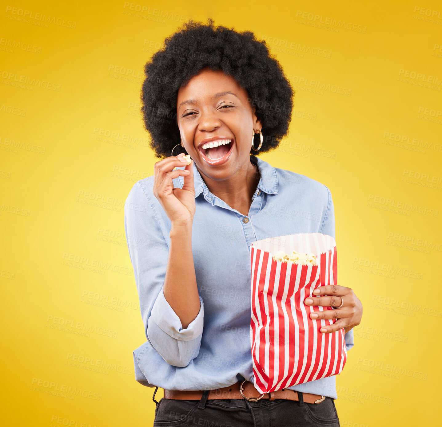 Buy stock photo Happy, smile and popcorn with black woman in studio for movie, streaming service and cinema. Laugh, comedy and theatre with female and snack isolated on yellow background for food, tv and film