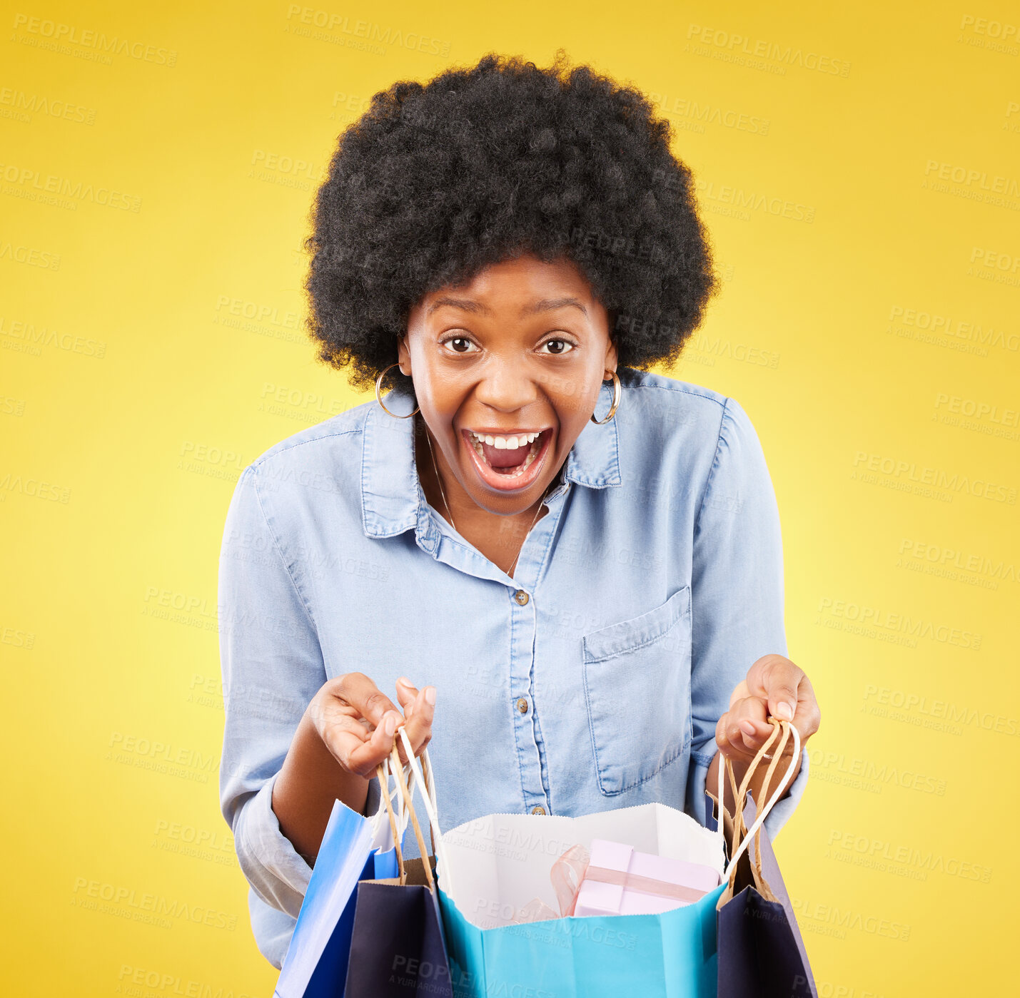 Buy stock photo Portrait, wow and happy black woman shopping, excited and celebrating sale in studio on yellow background. Bag, shopper and face of girl customer cheerful for boutique, retail or store discount