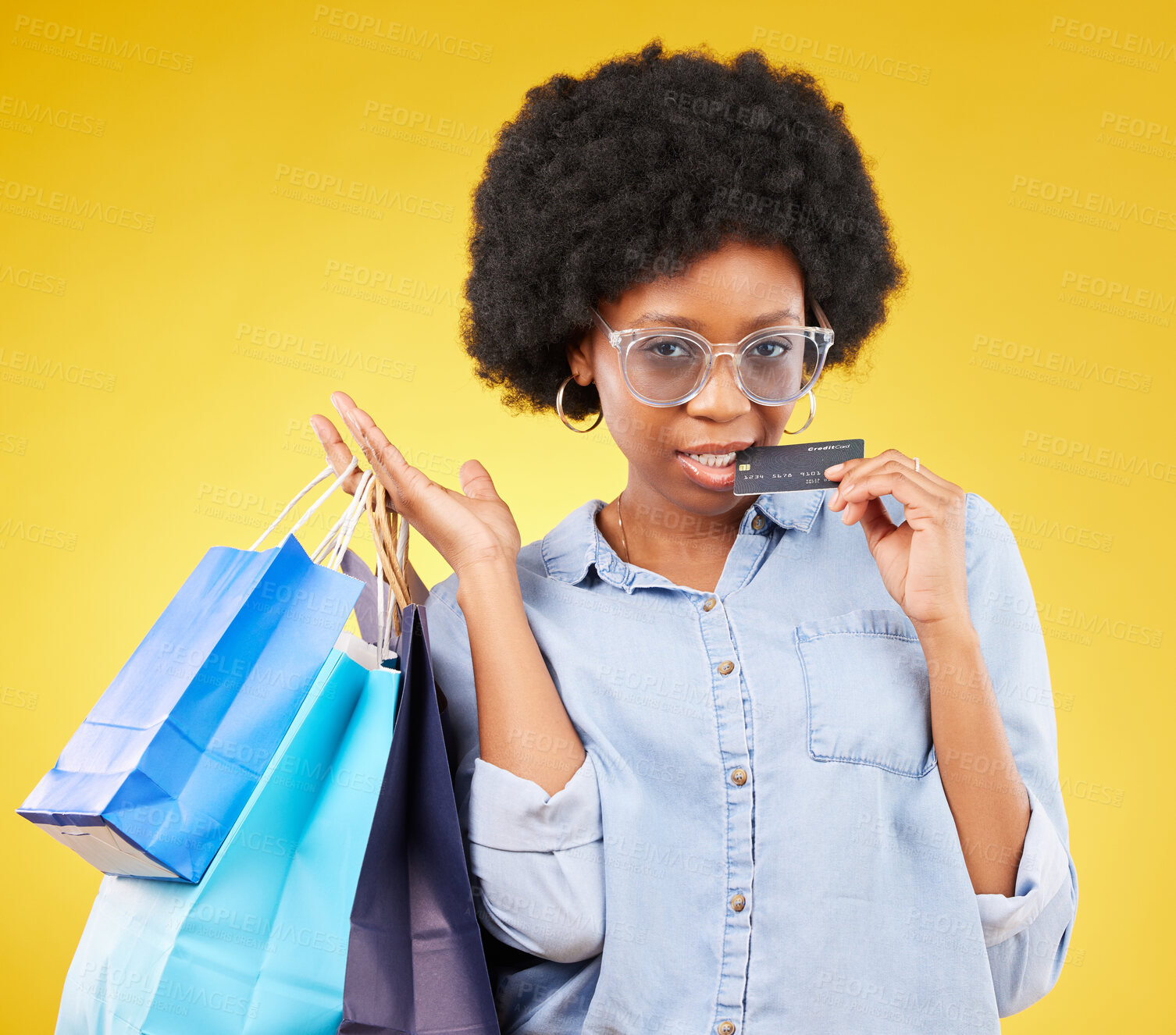 Buy stock photo Shopping bag, retail credit card and portrait black woman with sales product, studio fashion deal or mall store attitude. Commerce market, discount gift or female customer biting on yellow background