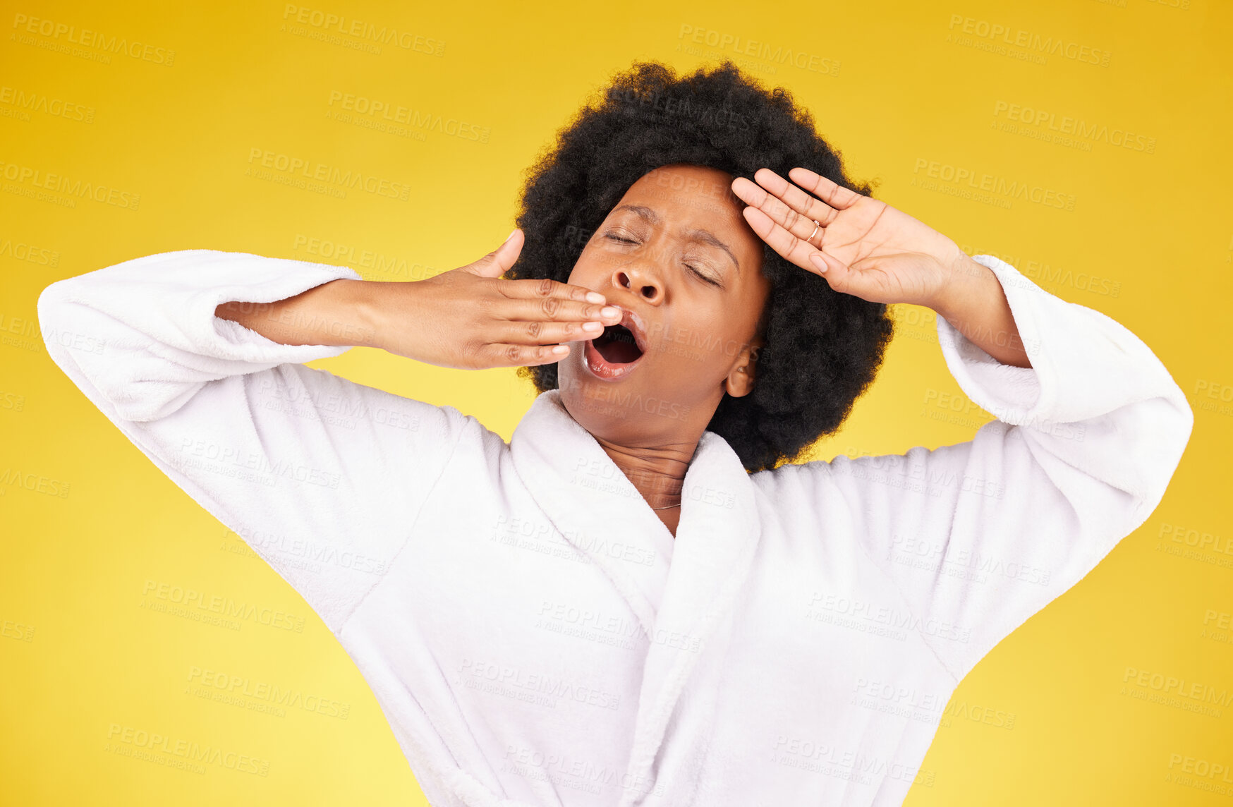 Buy stock photo Yawn, morning and wake up with a black woman in studio on a yellow background wearing a bathrobe. Relax, tired or rest with an exhausted young female yawning and stretching after sleeping