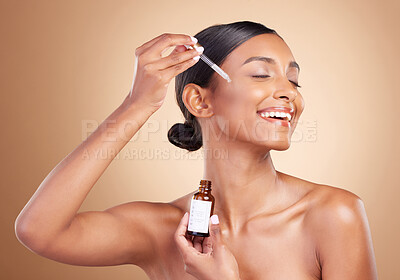 Buy stock photo Woman, dropper and retinol on face for skincare beauty or cosmetics against a studio background. Happy beautiful female model applying oil drop to skin for hydration, moisturizer or facial treatment