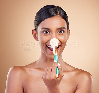 Portrait of woman, funny or makeup brush for beauty, cosmetic beauty or self care in studio background. Happy, model face or crazy eyes of Indian girl with cosmetics brush, skincare or application