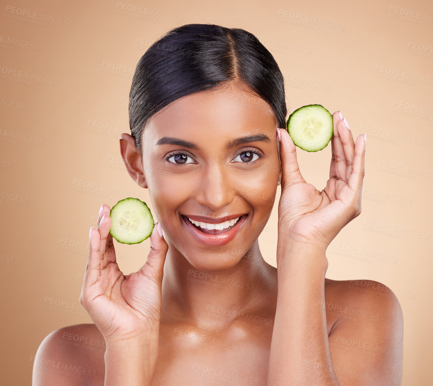 Buy stock photo Portrait, beauty and cucumber with a woman in studio on a beige background to promote natural skincare. Face, fruit and organic with an attractive young female posing for cosmetics or luxury wellness