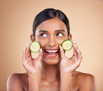 Buy stock photo Woman, thinking and cucumber for natural skincare, beauty and nutrition cosmetics against a studio background. Happy female holding vegetables in thought for healthy organic diet or facial treatment