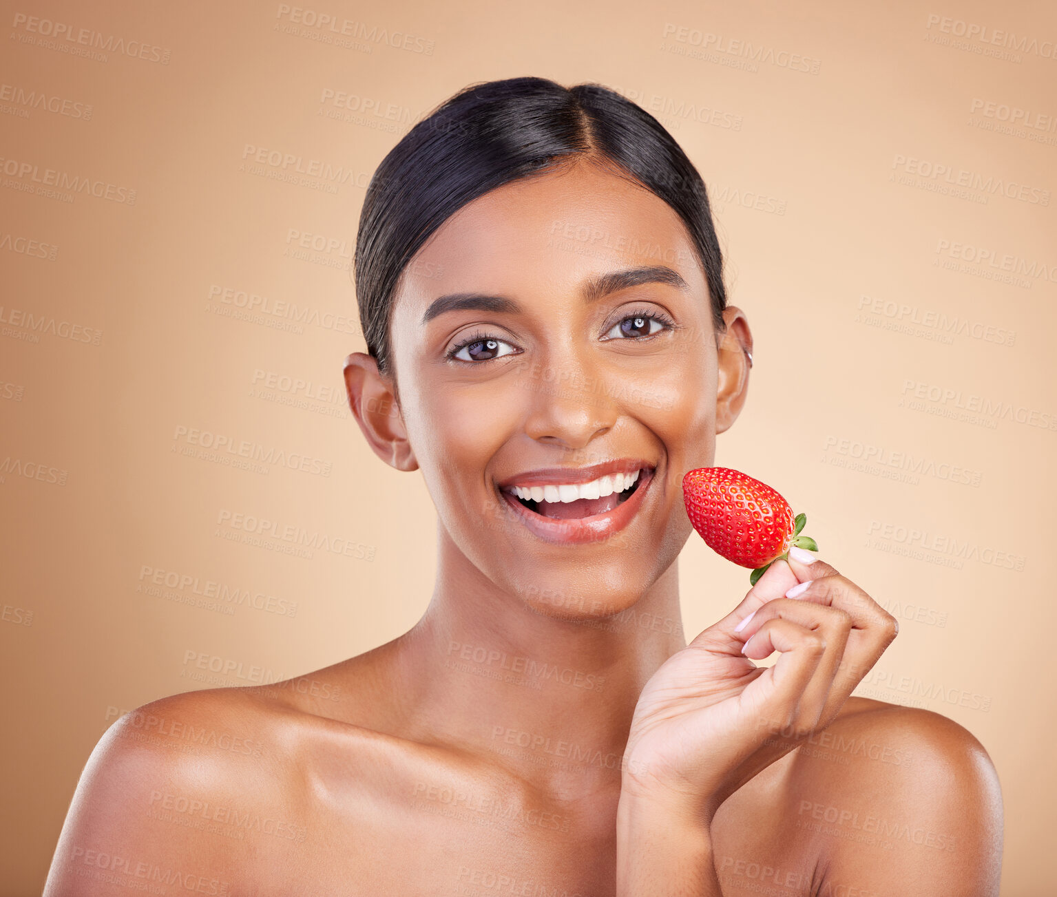 Buy stock photo Portrait, skincare and strawberry with a model woman in studio on a beige background to promote beauty. Face, fruit and nutrition with an attractive female posing for organic or natural cosmetics