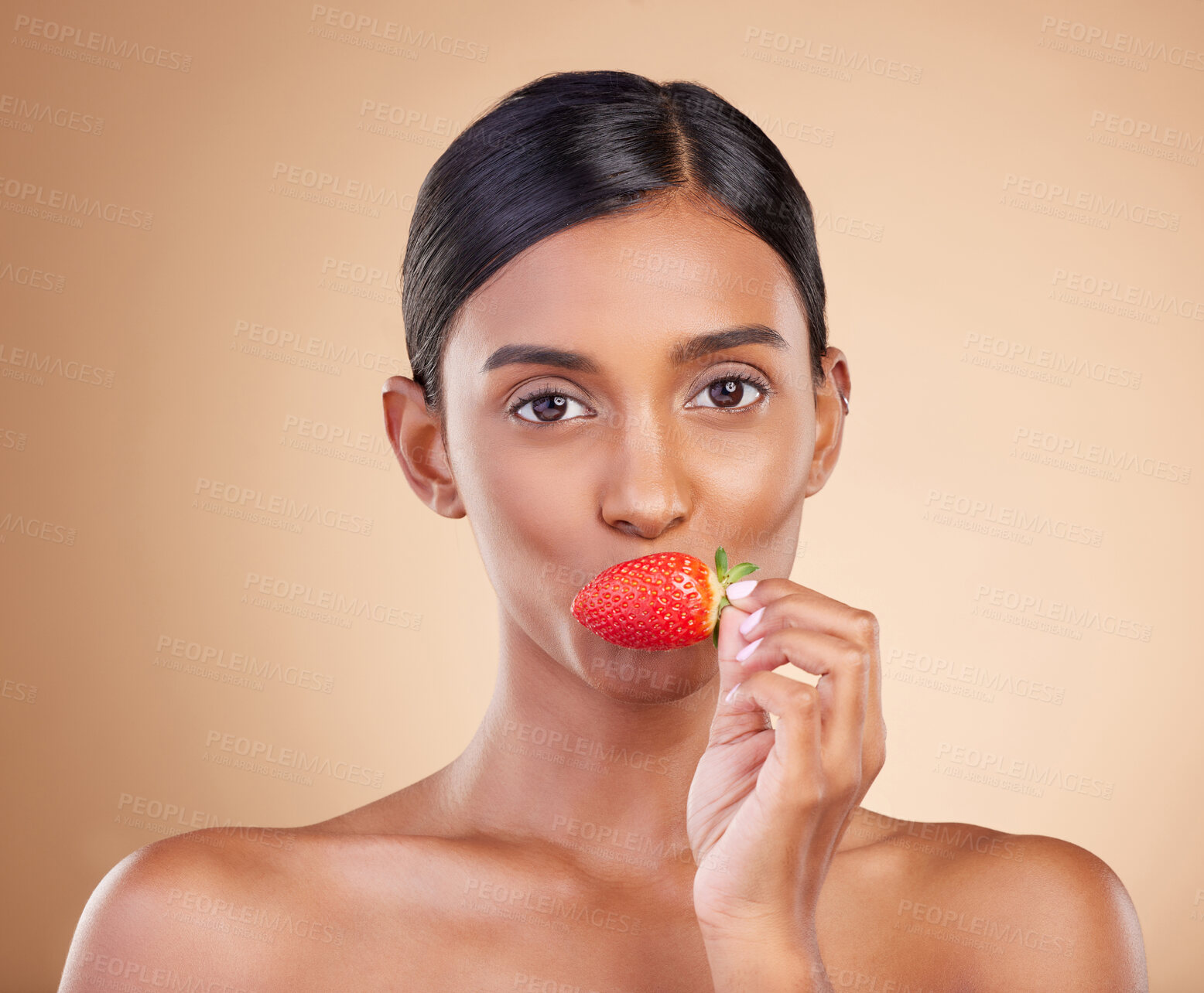 Buy stock photo Eating strawberry, portrait or healthy Indian woman with skincare beauty or wellness in headshot. Food nutrition, face or young girl model with vitamin c or red fruits isolated on studio background