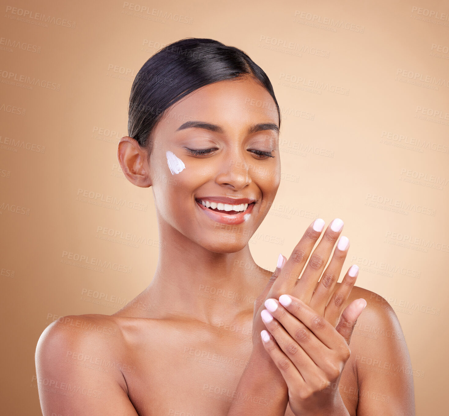 Buy stock photo Hands, skincare or happy woman with cream product for beauty or young face isolated on studio background. Body cosmetics, smile or Indian girl with facial moisturizer or dermatology lotion for glow
