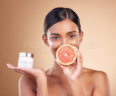 Buy stock photo Grapefruit, portrait or happy woman with cream product for face beauty or skincare isolated on studio background. Cosmetics glow, smile or Indian girl with facial moisturizer or dermatology lotion 