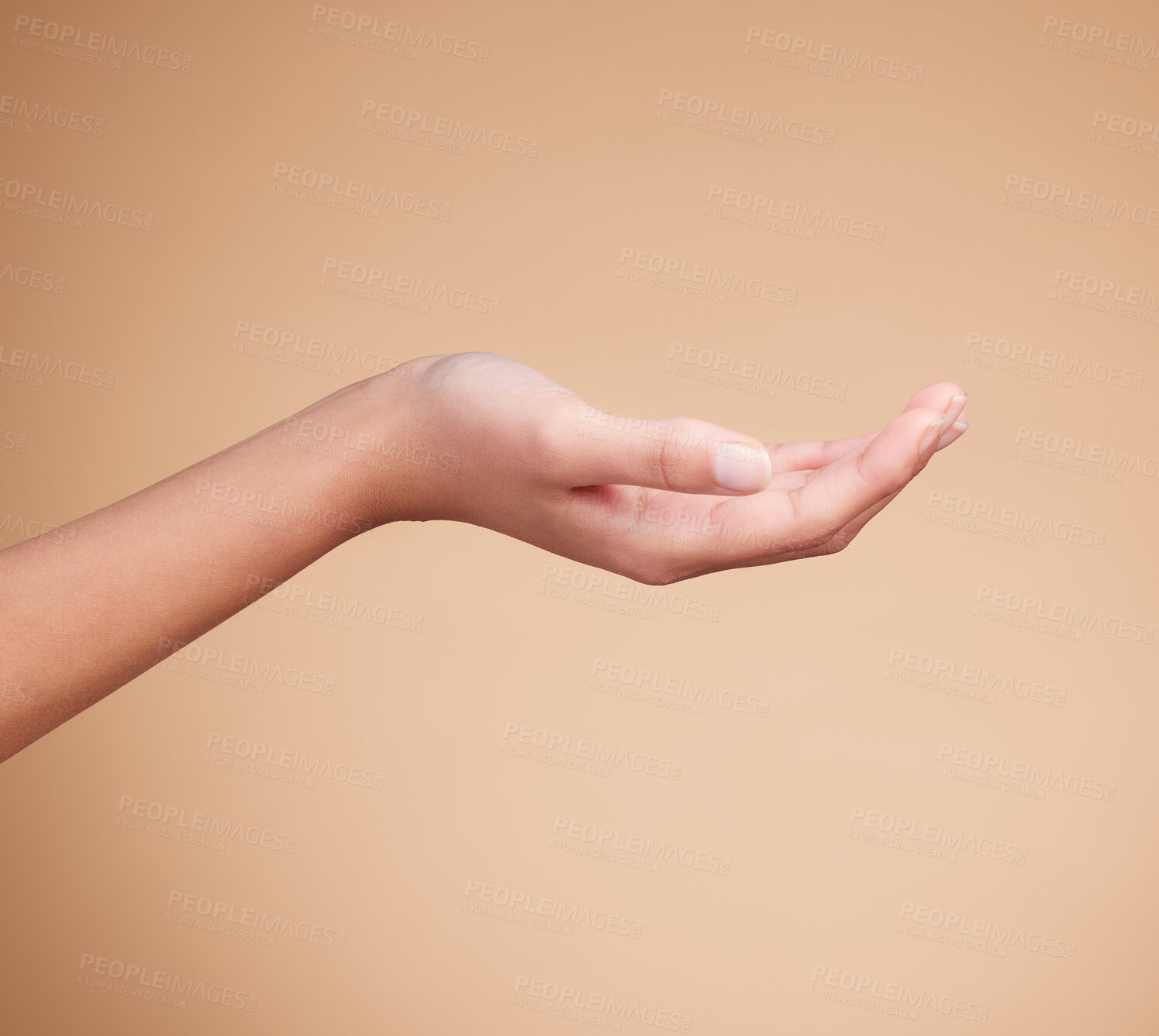 Buy stock photo Hands, palm and product placement for mockup in studio isolated on a brown background. Skincare, dermatology and woman model with hand out for marketing, advertising or branding space for mock up.